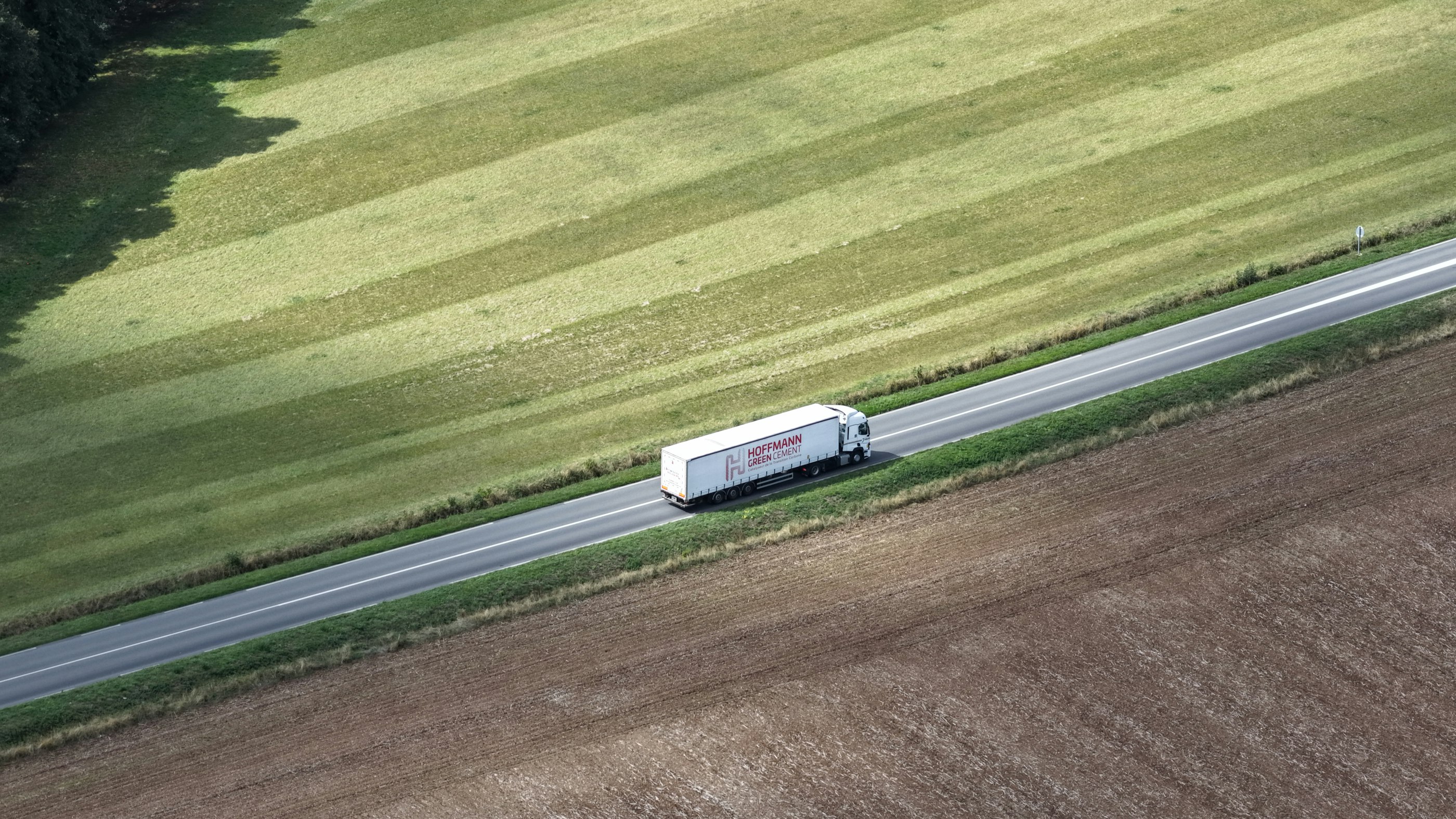 A tractor trailer travelling on an open road