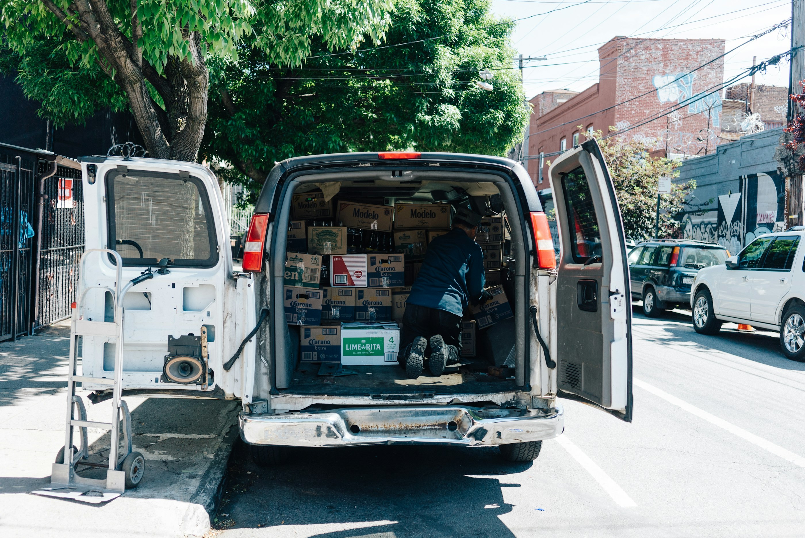 An open delivery van parked on a city street