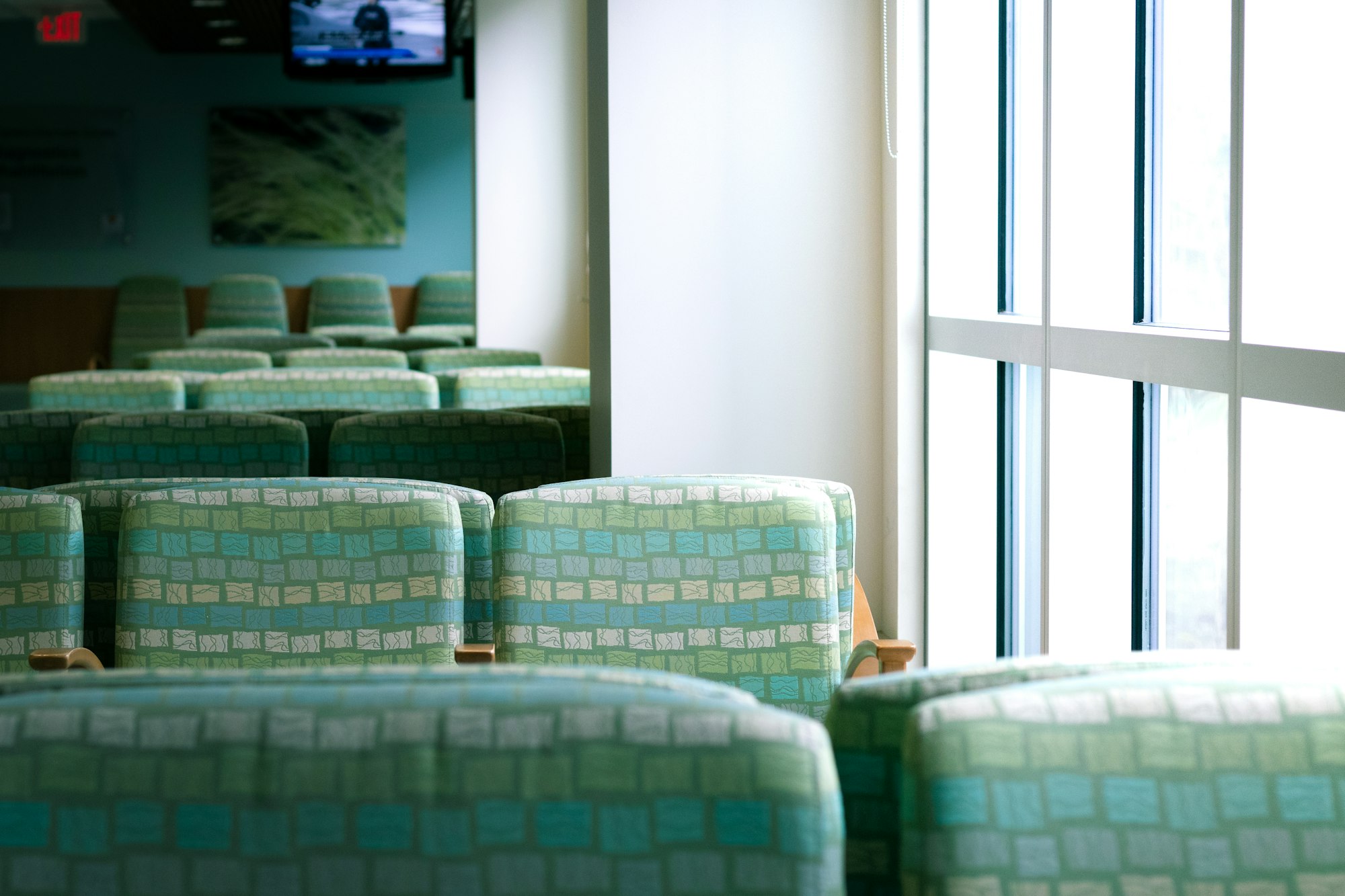 A quiet hospital waiting room beside bright windows