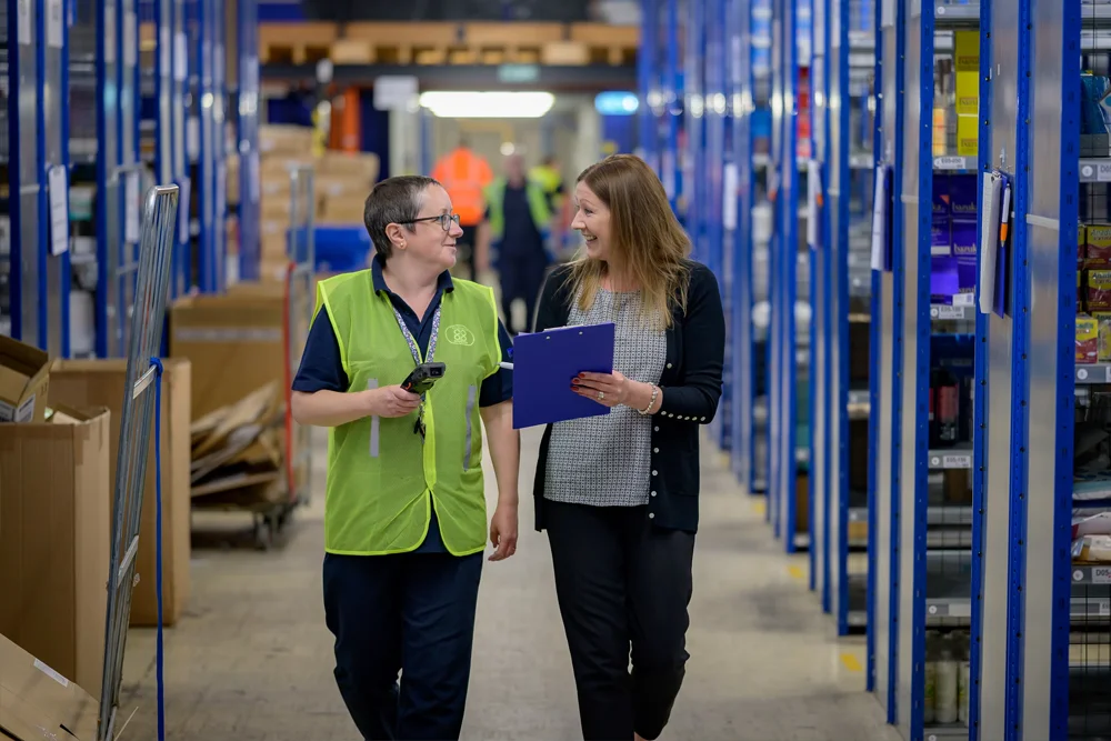 Warehouse workers reviewing a clipboard