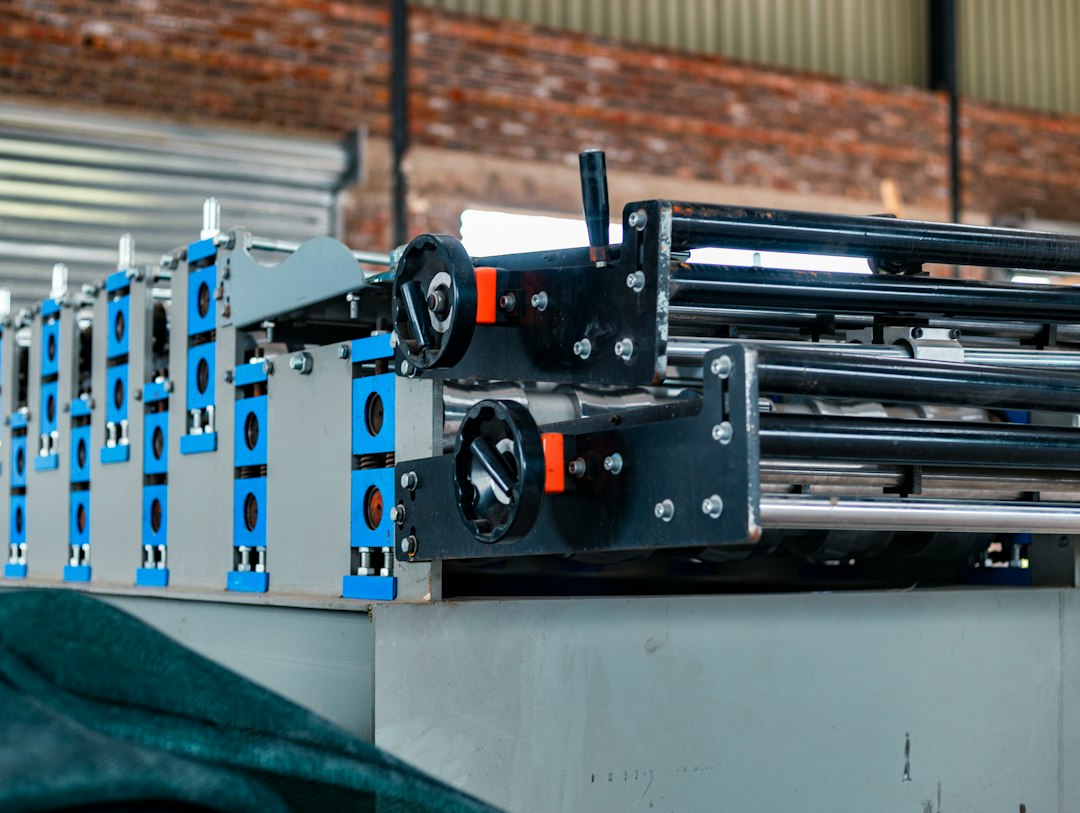 Close-up of industrial roll-forming machinery in a factory