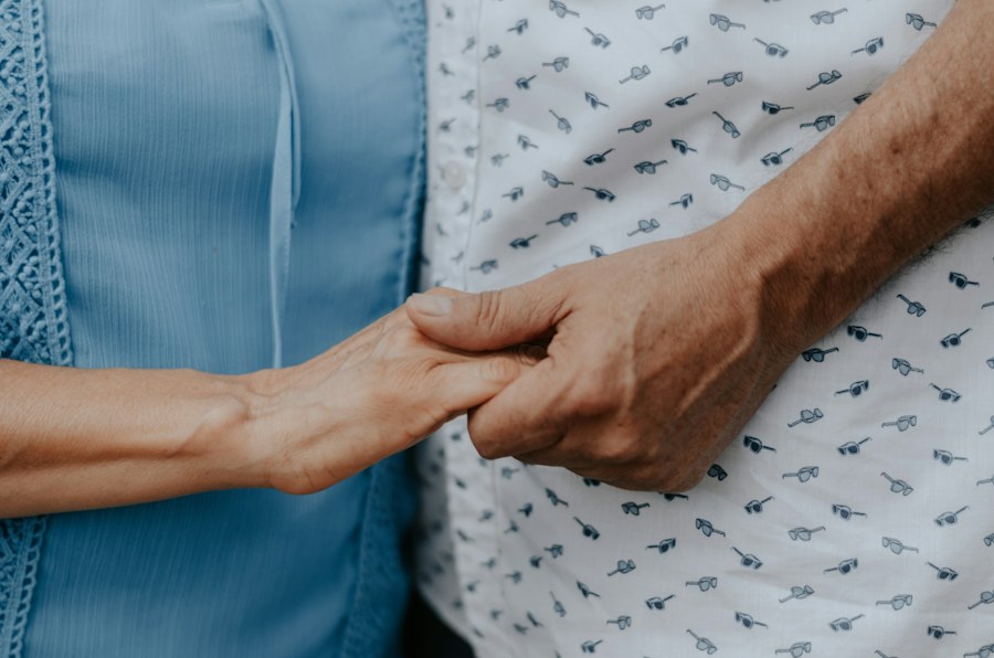 Two people holding hands in a gesture of support