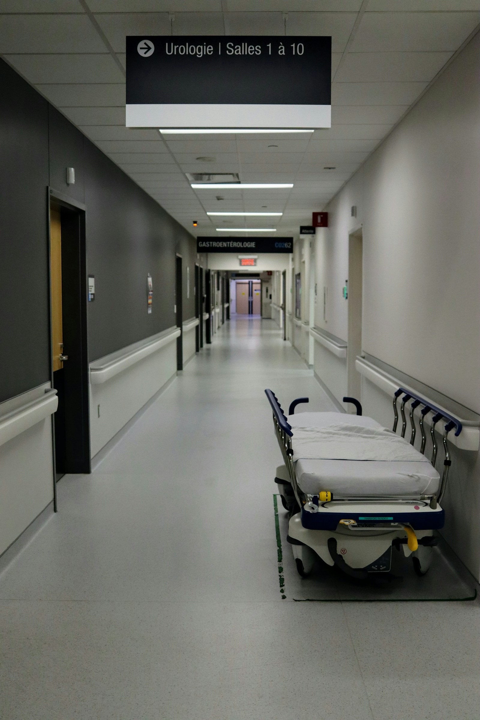 An empty hospital corridor with a patient trolley