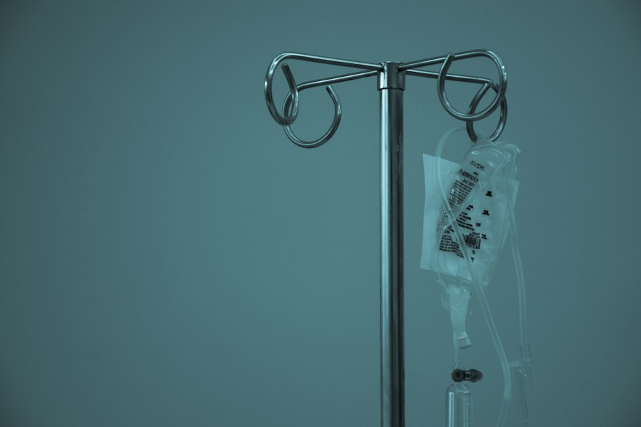 An IV bag hanging from a stand in a medical setting