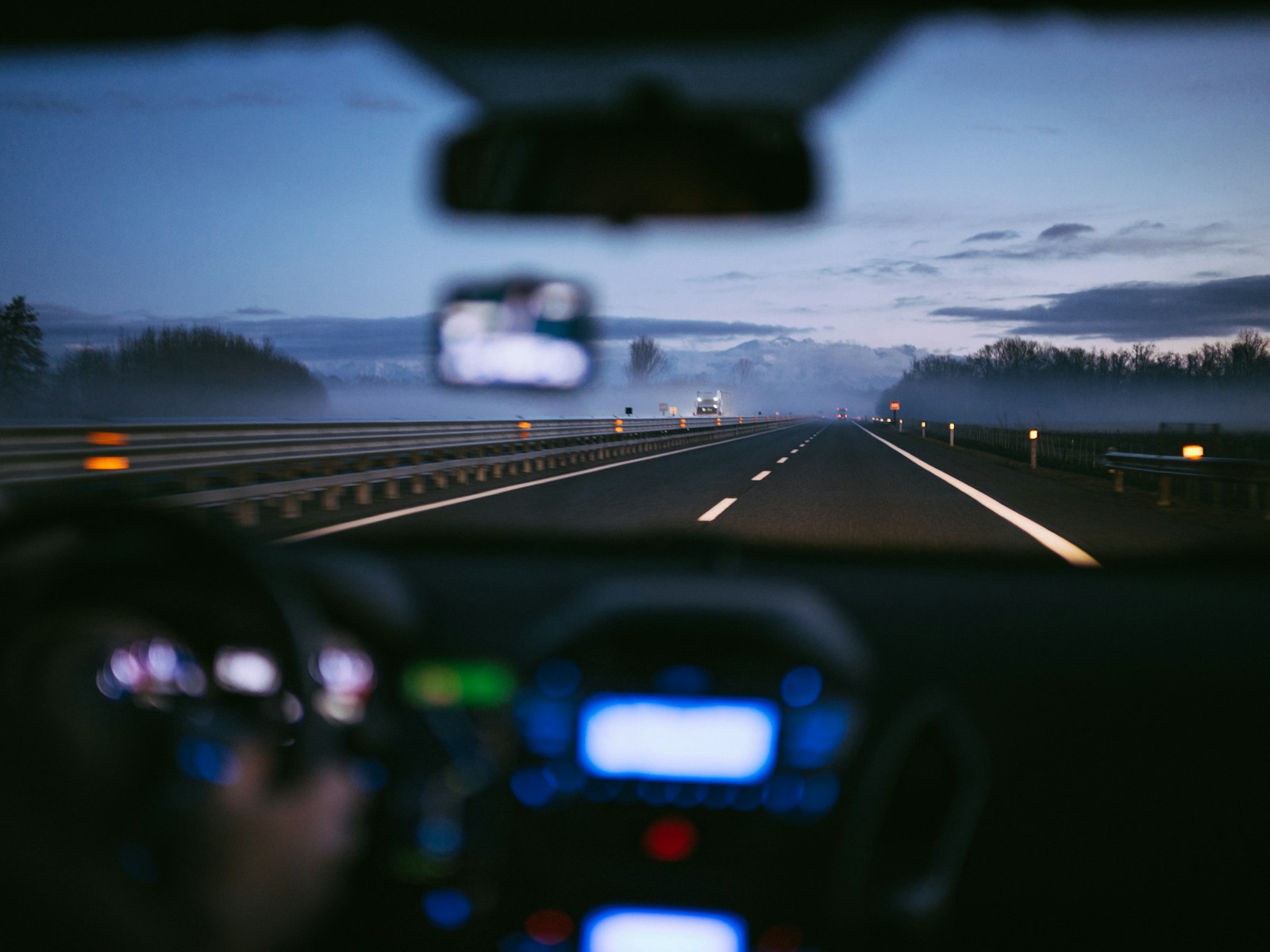 A view from inside a car on a misty highway