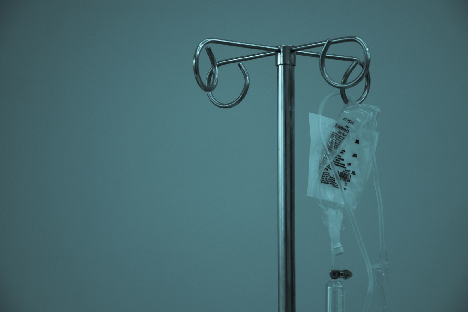 An IV bag hanging from a stand in a medical setting
