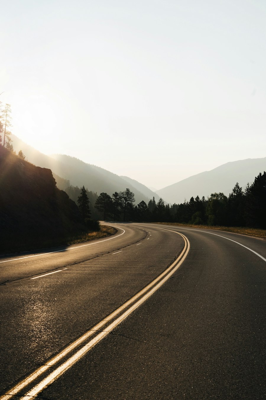 A curving road through a wooded landscape