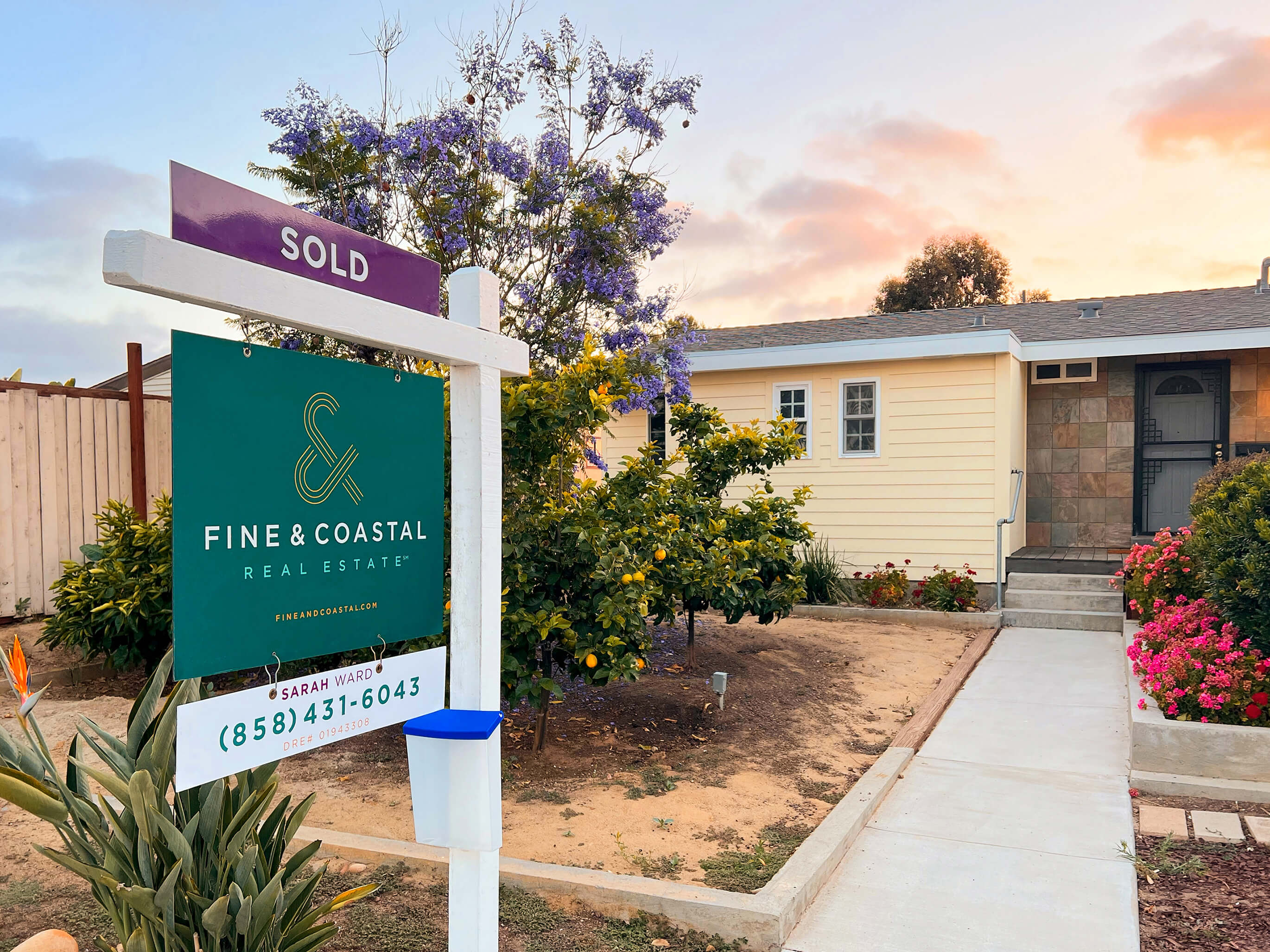 image of fine and coastal for sale sign in a front yard