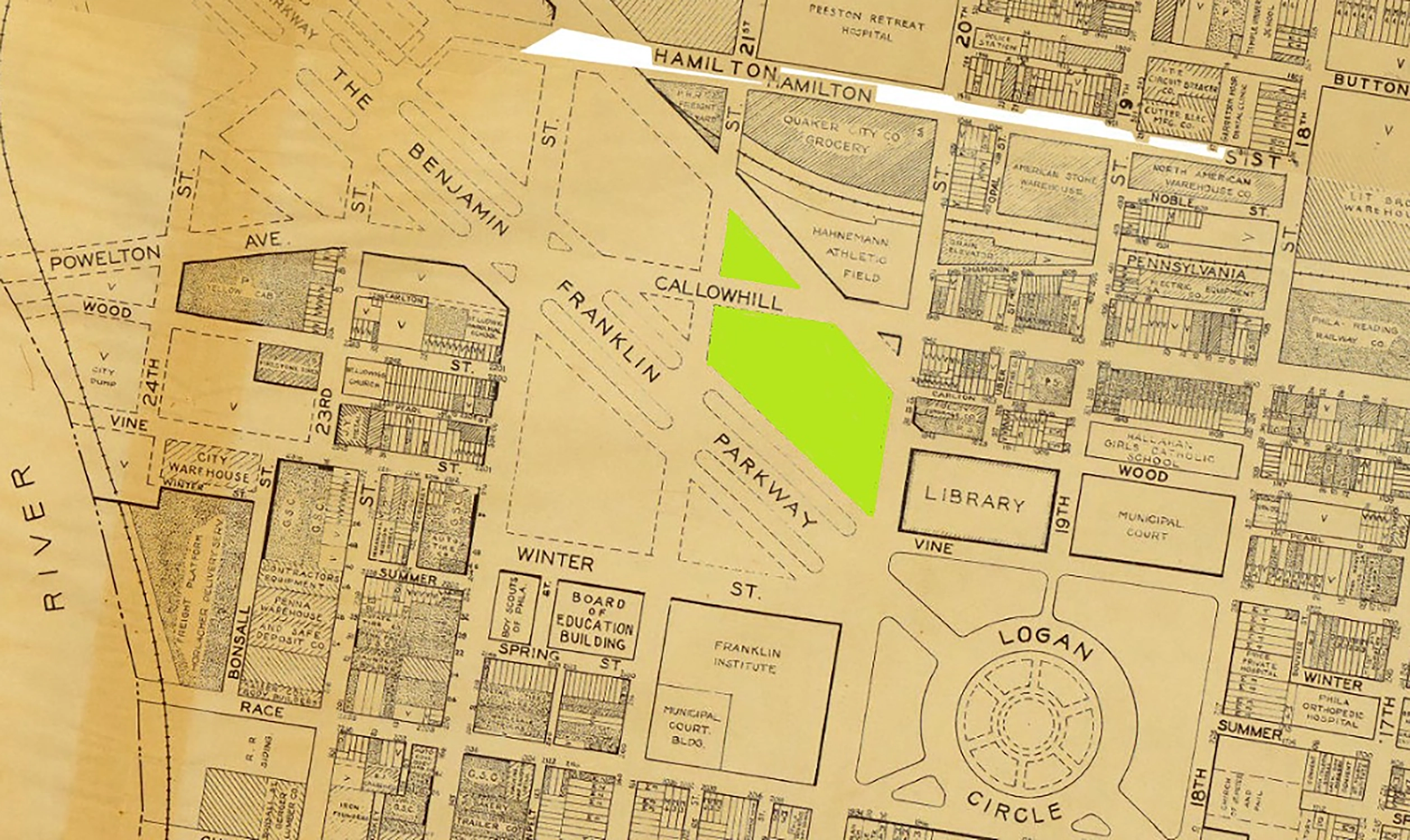 Vintage city map highlighting two green triangular areas near Franklin Parkway, Callowhill, and Benjamin streets, showing labeled streets, buildings such as a library, board of education building, and municipal court, with Logan Circle prominently displayed.