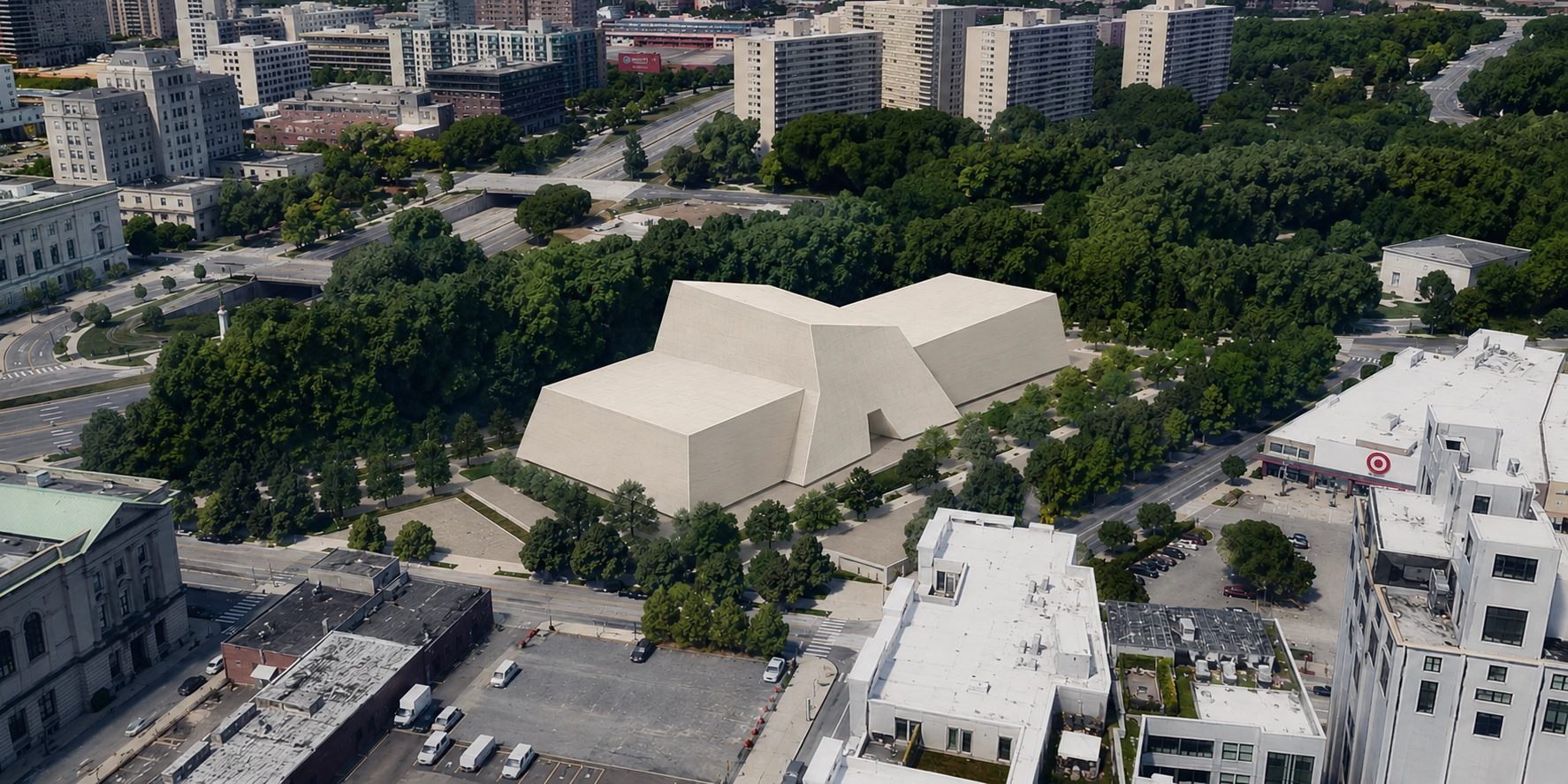 A large modern beige building with angular shapes set in a park-like area surrounded by dense green trees, with city buildings, roads, and a Target store nearby.