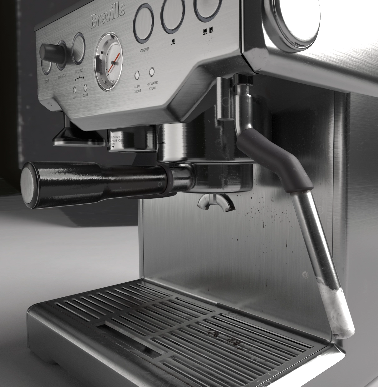 Close-up of a stainless steel Breville espresso machine showing the portafilter handle, steam wand with rubber grip, pressure gauge, control knobs, and drip tray.