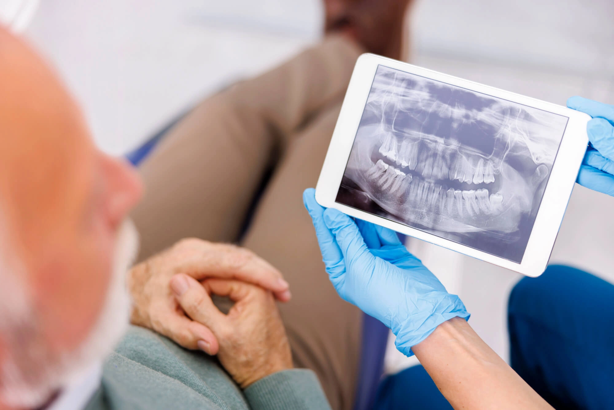 dentist showing dental x-rays to a male patient
