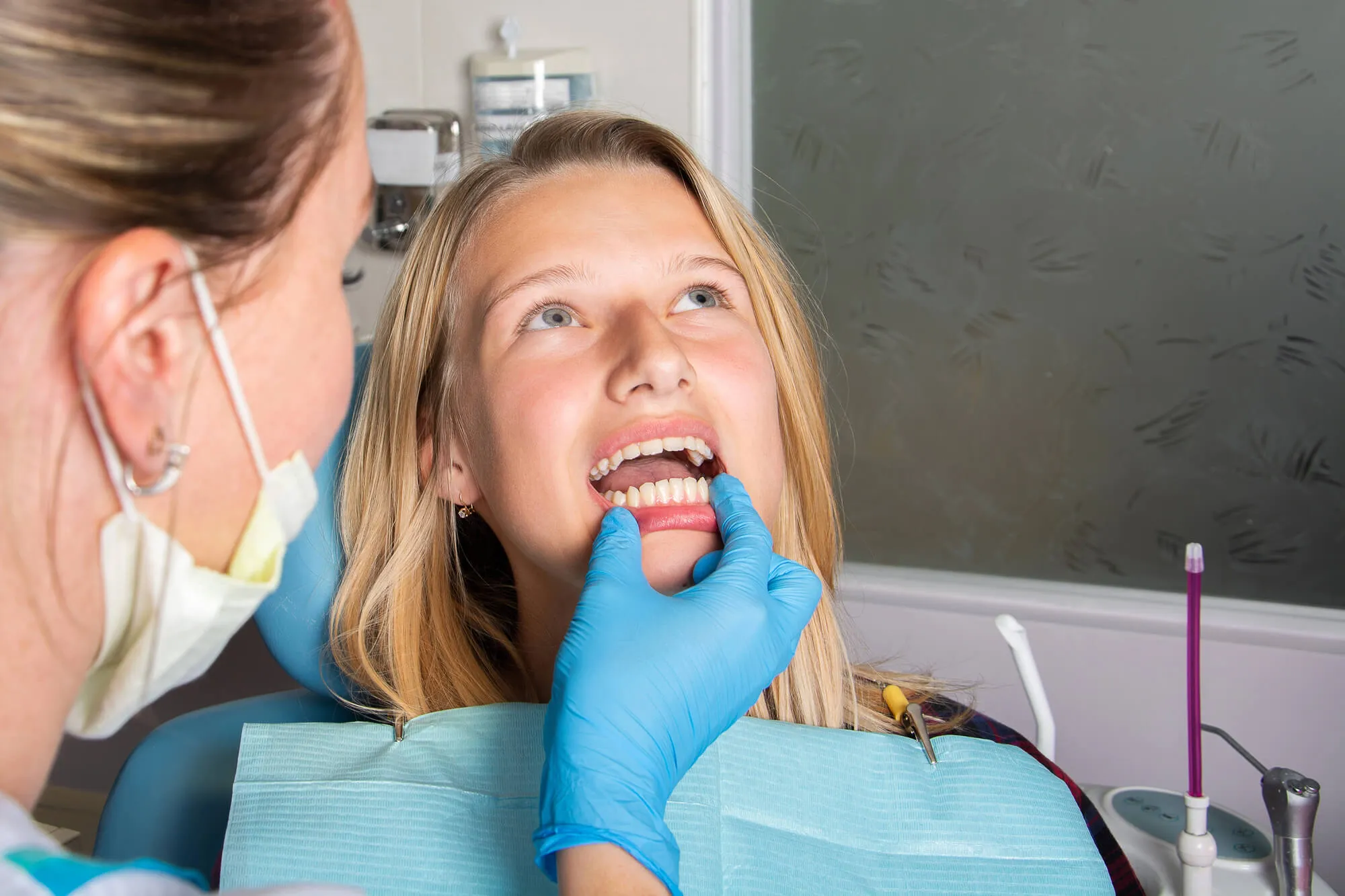 woman getting a dental exam at the dentist