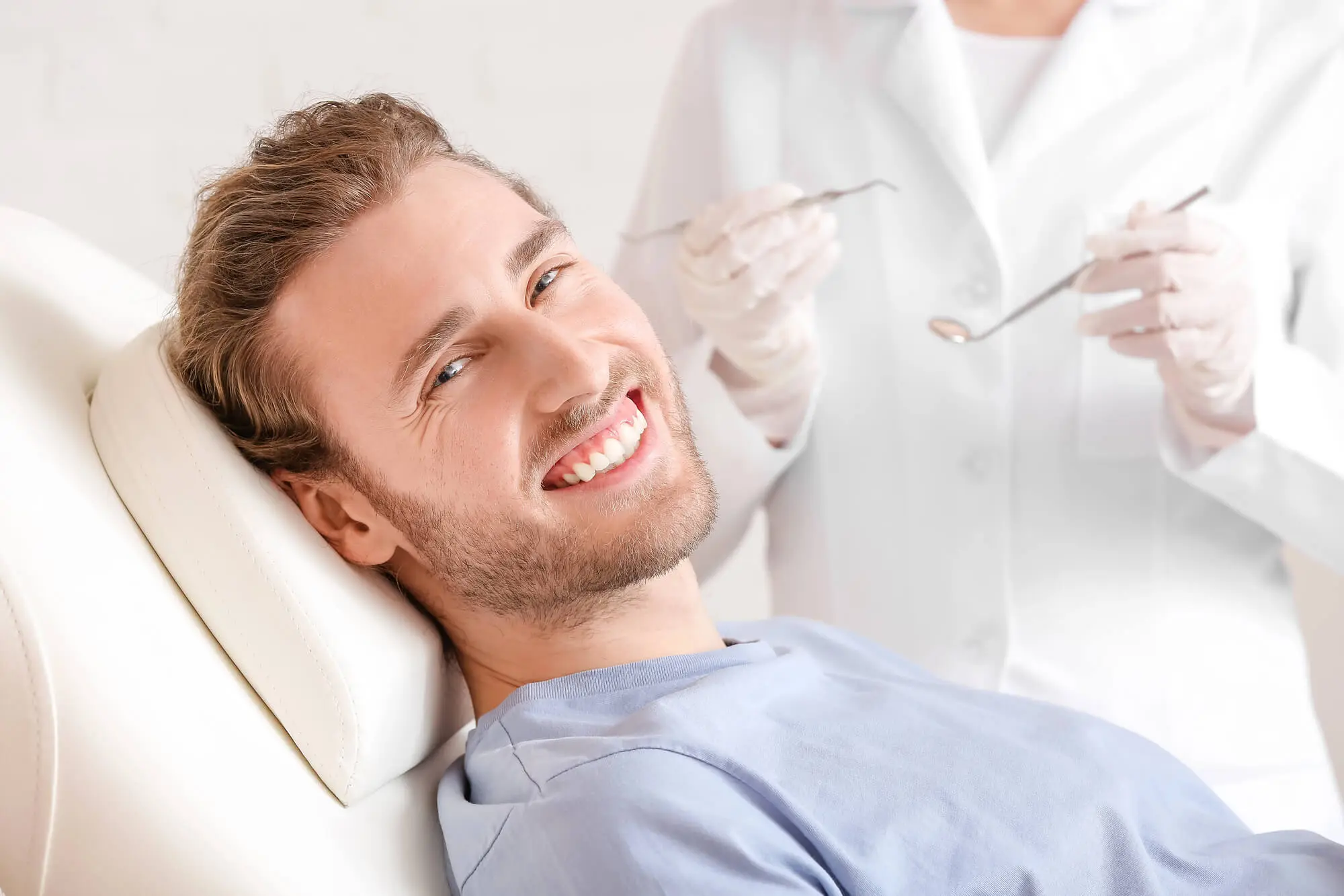man smiling at the dentist