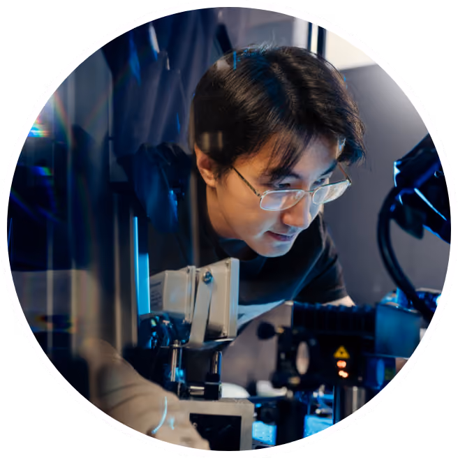 A lab member leaned over a piece of lab equipment