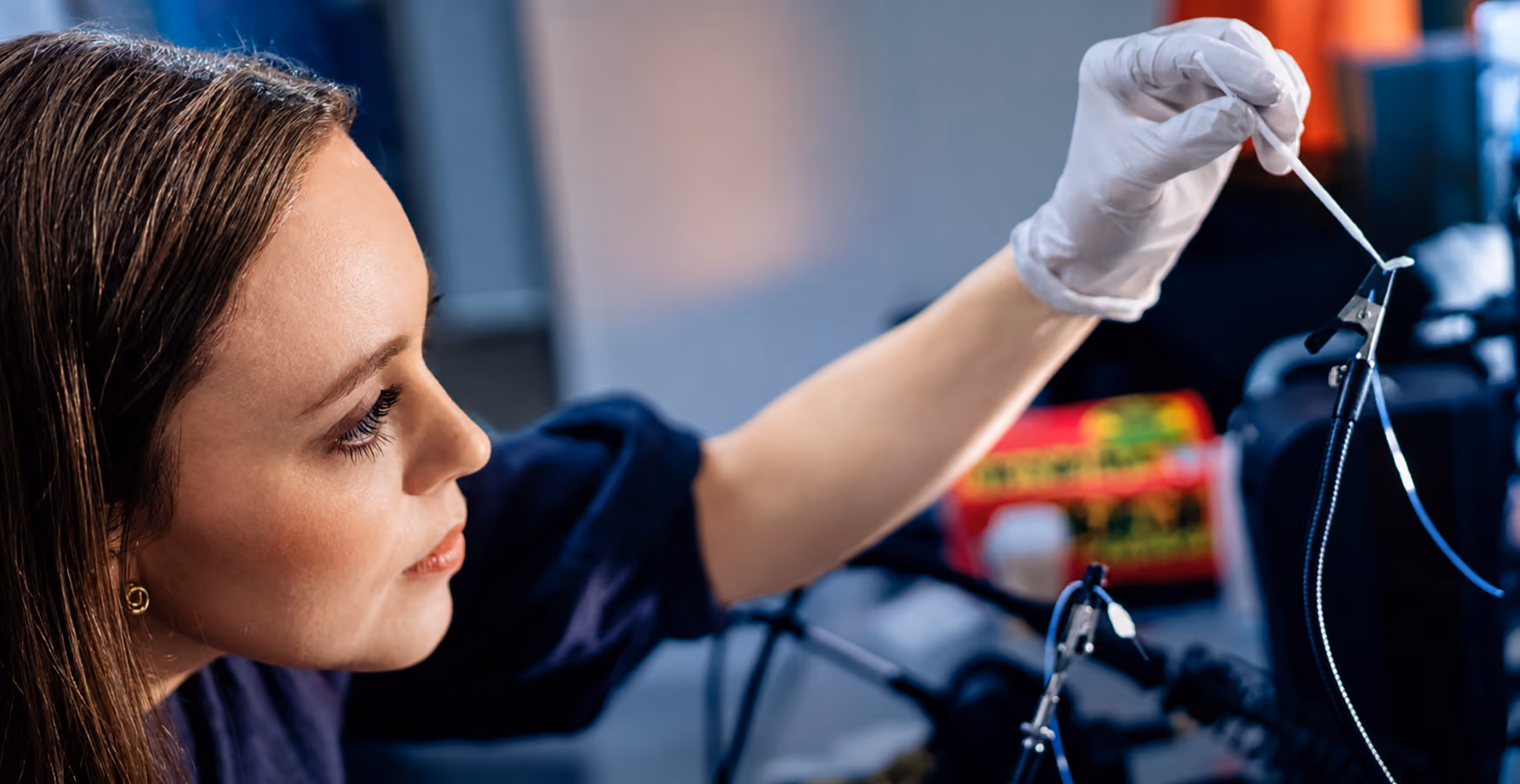 A lab member working with a piece of laboratory equipment.