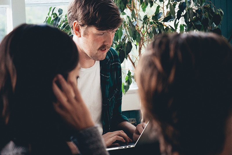 Geoff House, Elise Fung, and Evan McEldowney discussing design strategies