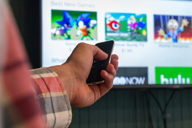 Closeup of Jon Emminizer's hand showing off the Apple TV