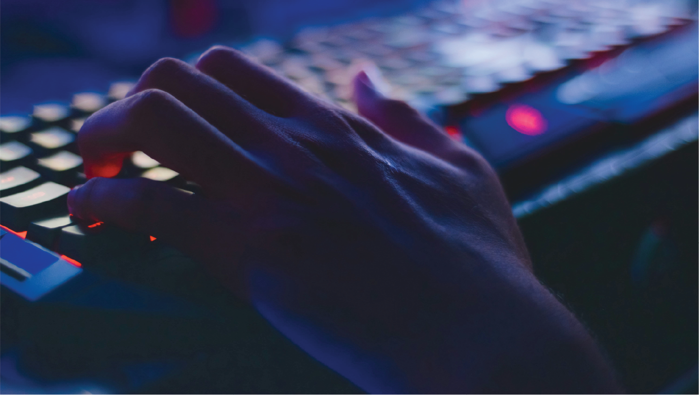 A hand typing on a keyboard