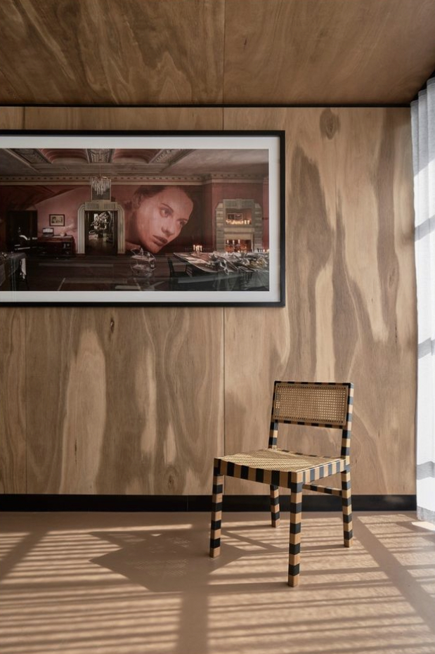 Artwork and chair in a timber-panelled room