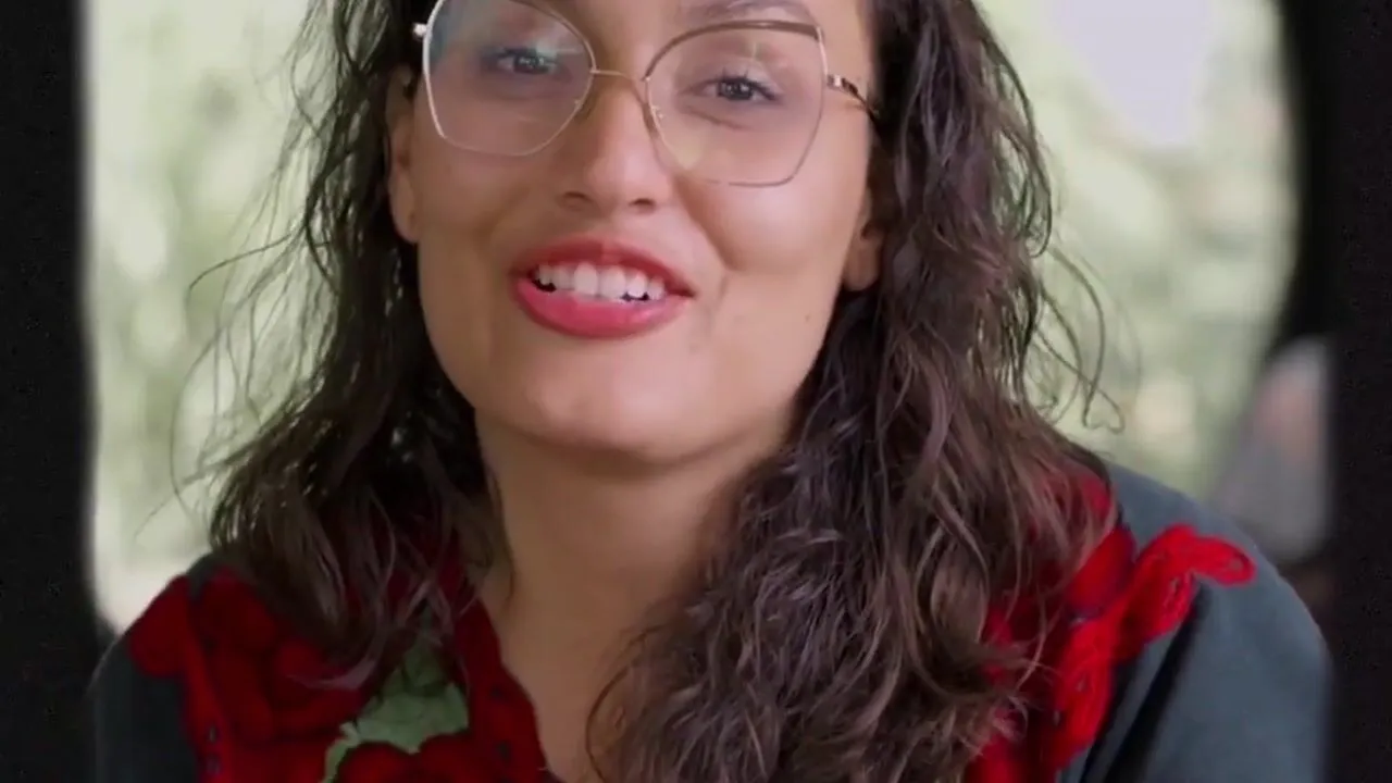 A dancer smiling as she speaks to camera in the Family Legacy film
