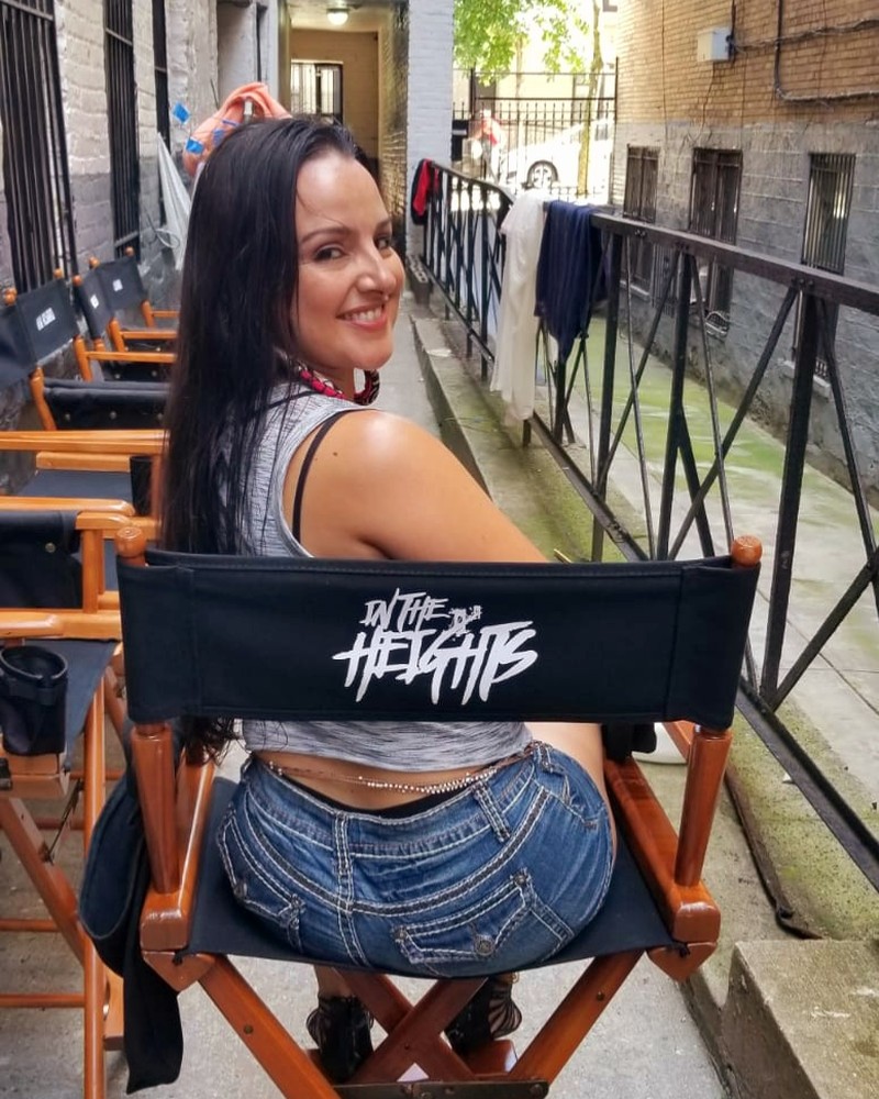 Cynthia Paniagua on the In the Heights set, seated in a production chair