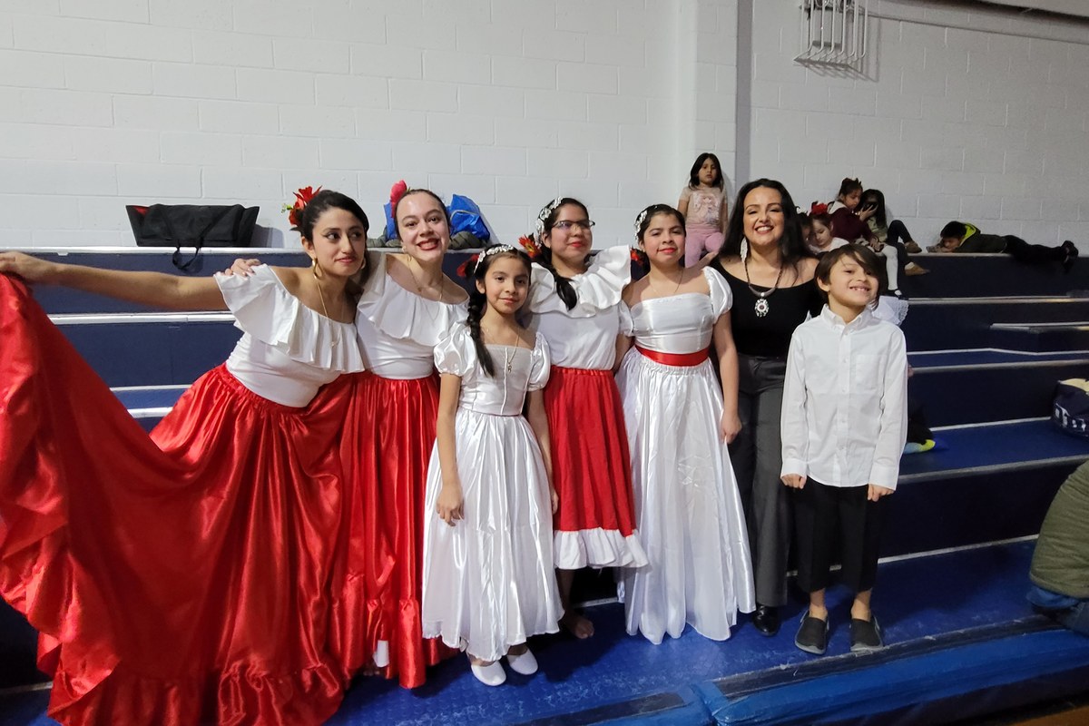Students in Peruvian costume with Cynthia Paniagua after a school presentation