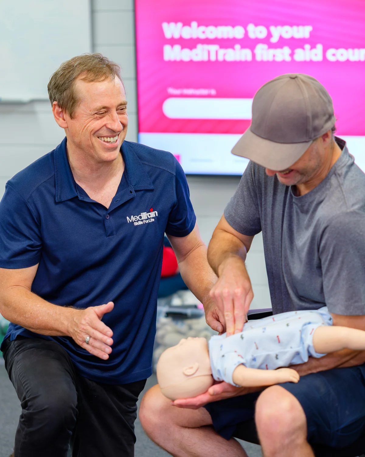 MediTrain instructor coaching a learner through infant CPR on a manikin