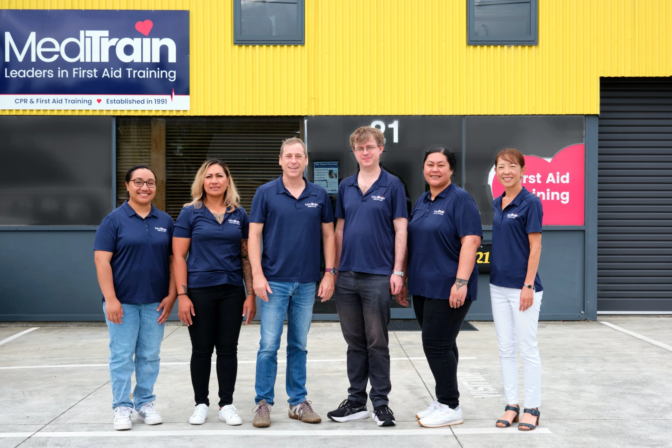 The MediTrain team in uniform outside the MediTrain head office in Auckland