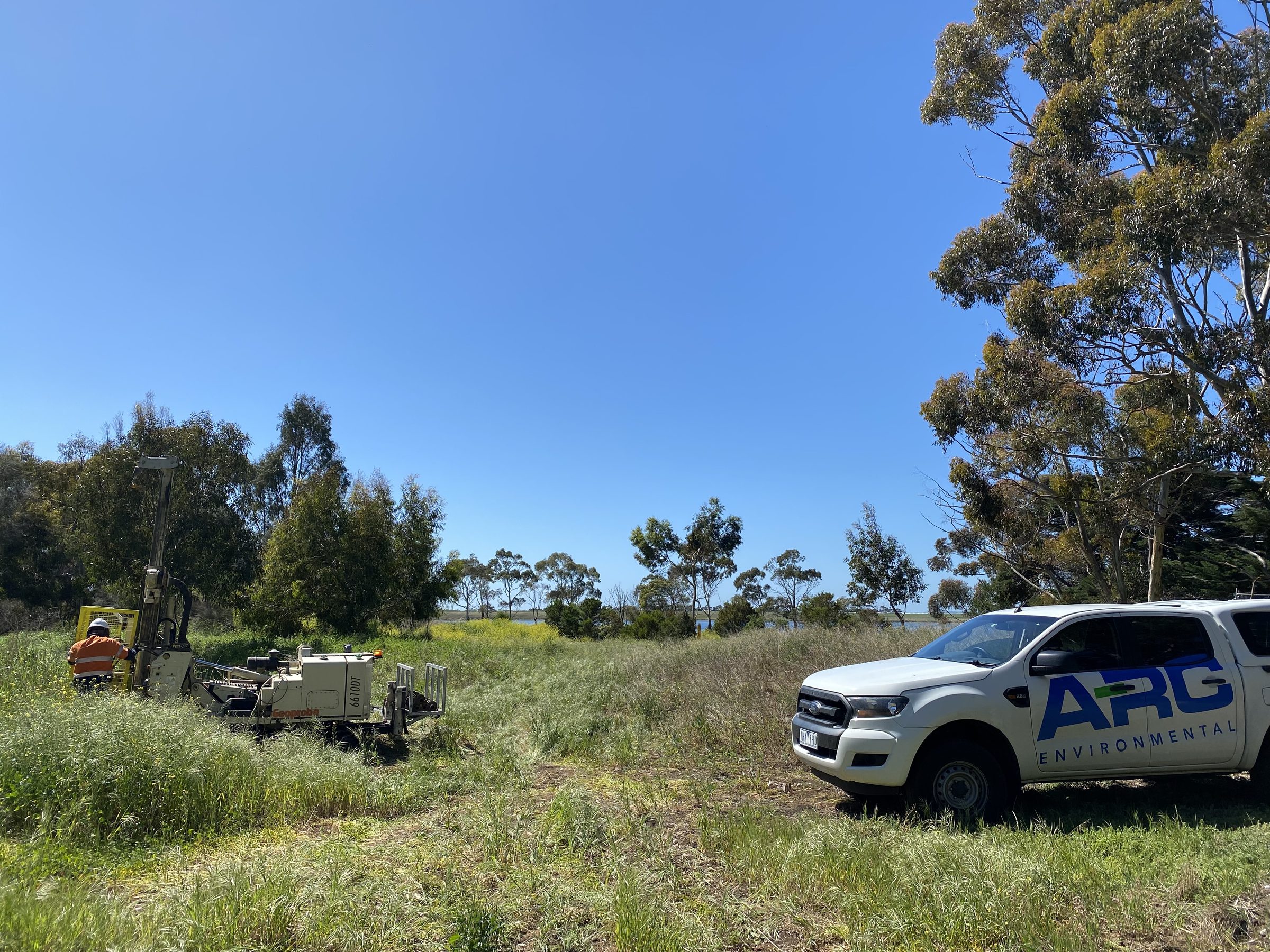 ARC Environmental vehicle and drill rig on a grassy site