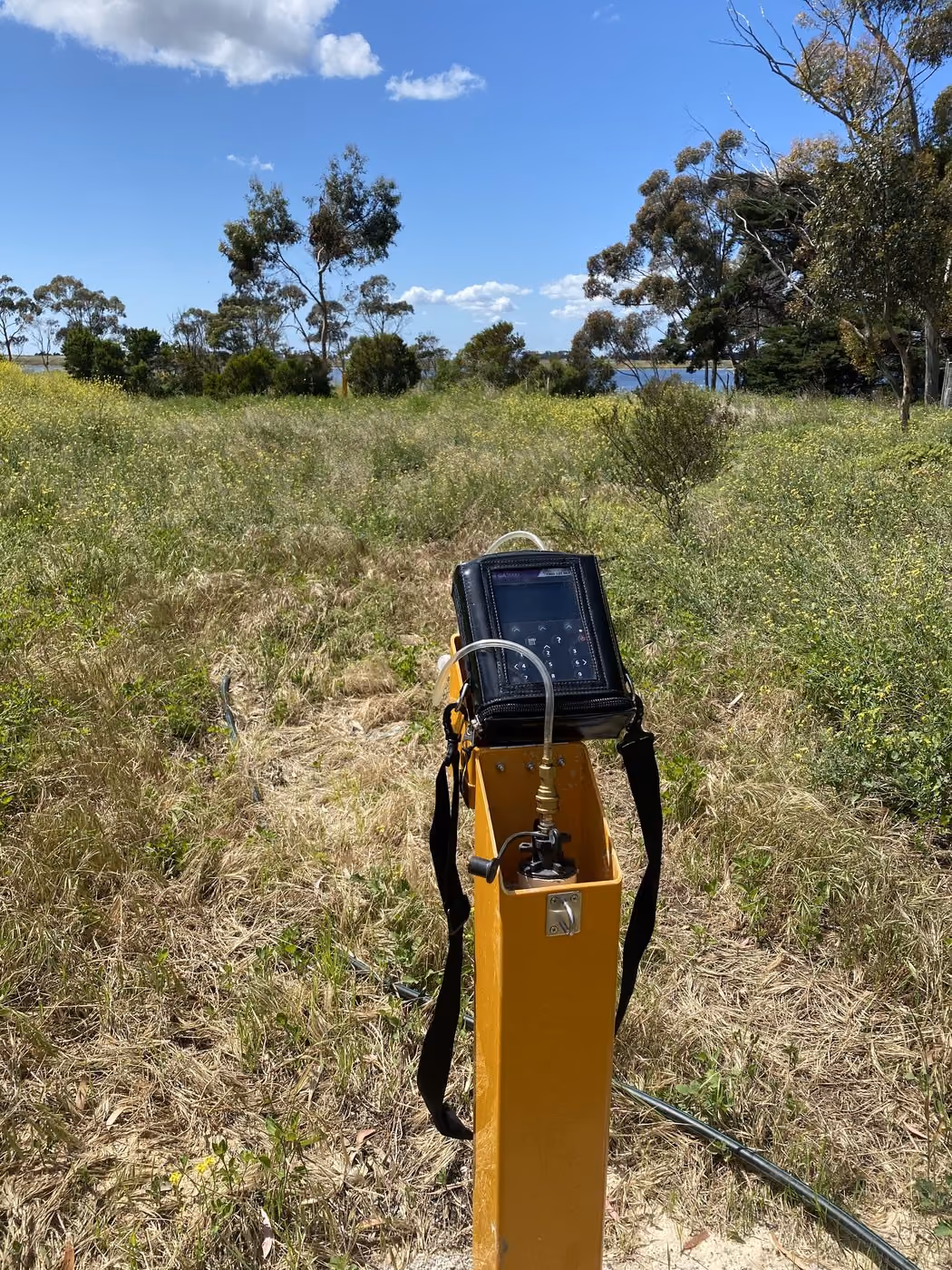 Gas monitoring bore with a data logger in open grassland