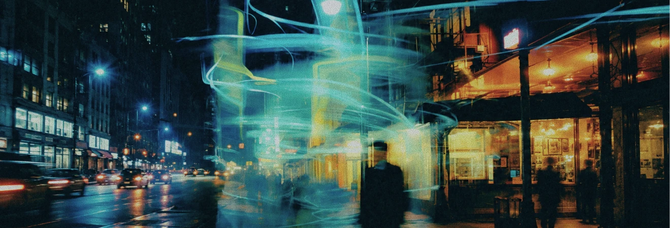 Nighttime urban street scene with blurred pedestrians and swirling light trails next to buildings with illuminated windows and streetlights.