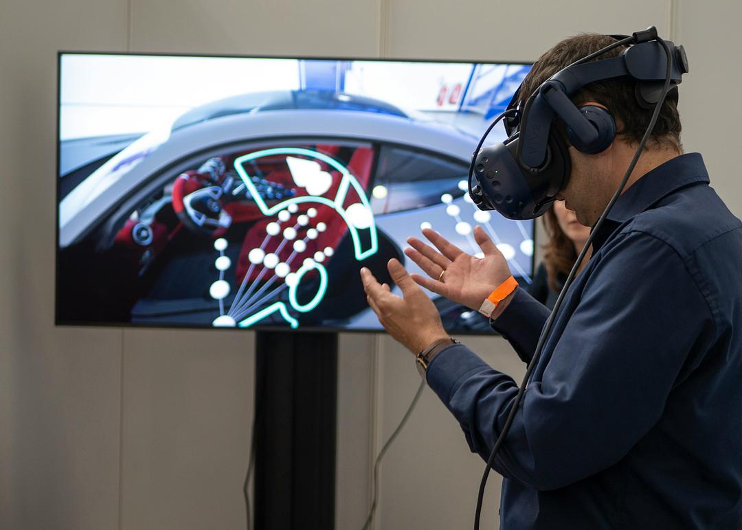 Row of virtual reality, augmented reality, and mixed reality headsets displayed side by side at an XR technology exhibition