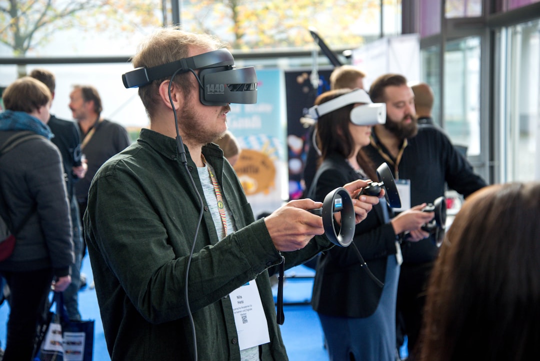 Person seated in a room wearing a head-mounted VR headset that covers their eyes and field of view