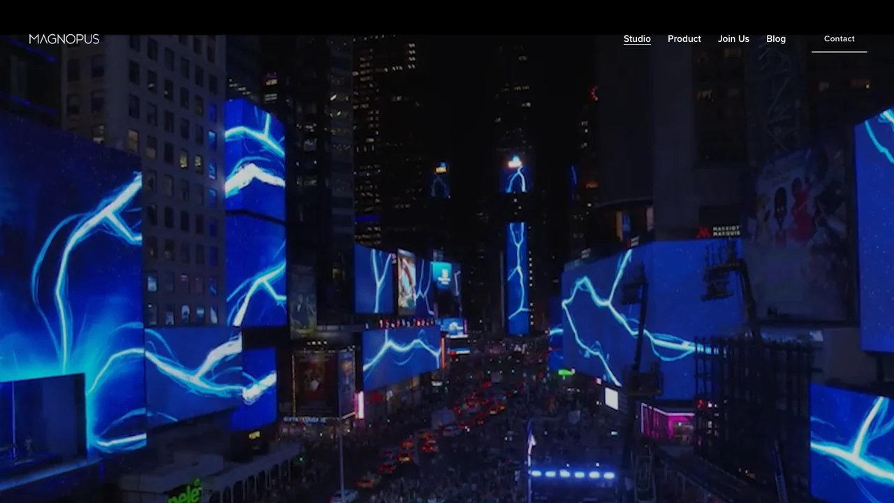 Magnopus website, showing a night cityscape with large animated light displays across building facades.