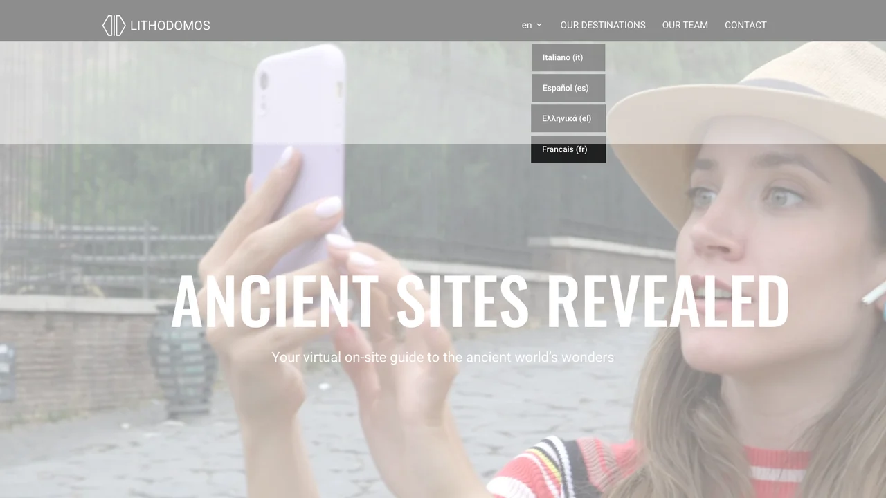 Lithodomos website homepage, headed Ancient sites revealed, showing a visitor holding a phone up at a heritage site.