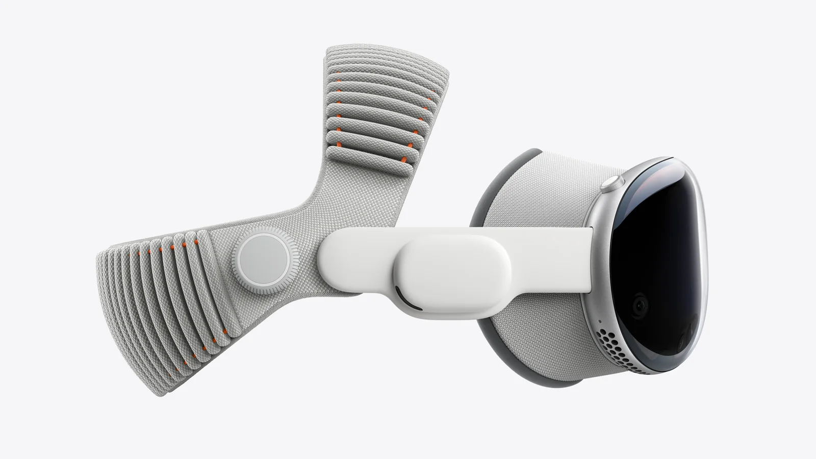 Apple Vision Pro fitted with the Dual Knit Band, photographed at an angle on a pale grey background so the ribbed knit strap and the fit dial are visible