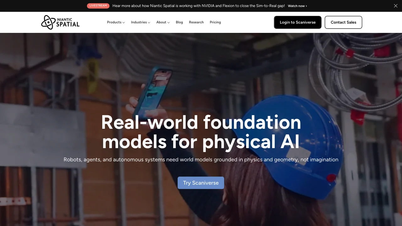 Niantic Spatial homepage with the headline Real-world foundation models for physical AI over a photograph of a worker scanning an industrial ceiling with a phone