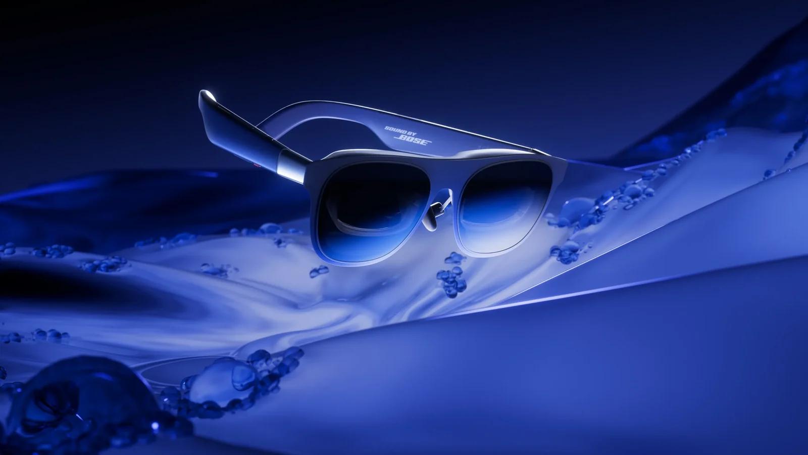 XREAL 1S display glasses photographed at an angle against a deep blue abstract background, with Sound by Bose printed on the temple arm