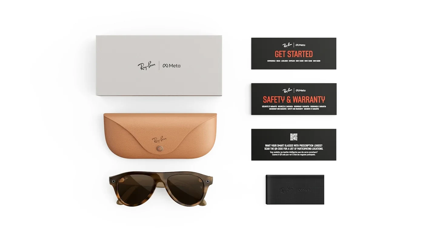 Flat lay of the contents of a Ray-Ban Meta Gen 3 Aviator box on a white background: an outer sleeve, a tan fold-over charging case, the tortoise Aviator glasses, a Get Started card, a Safety and Warranty card, a prescription card carrying a QR code, and a cleaning cloth
