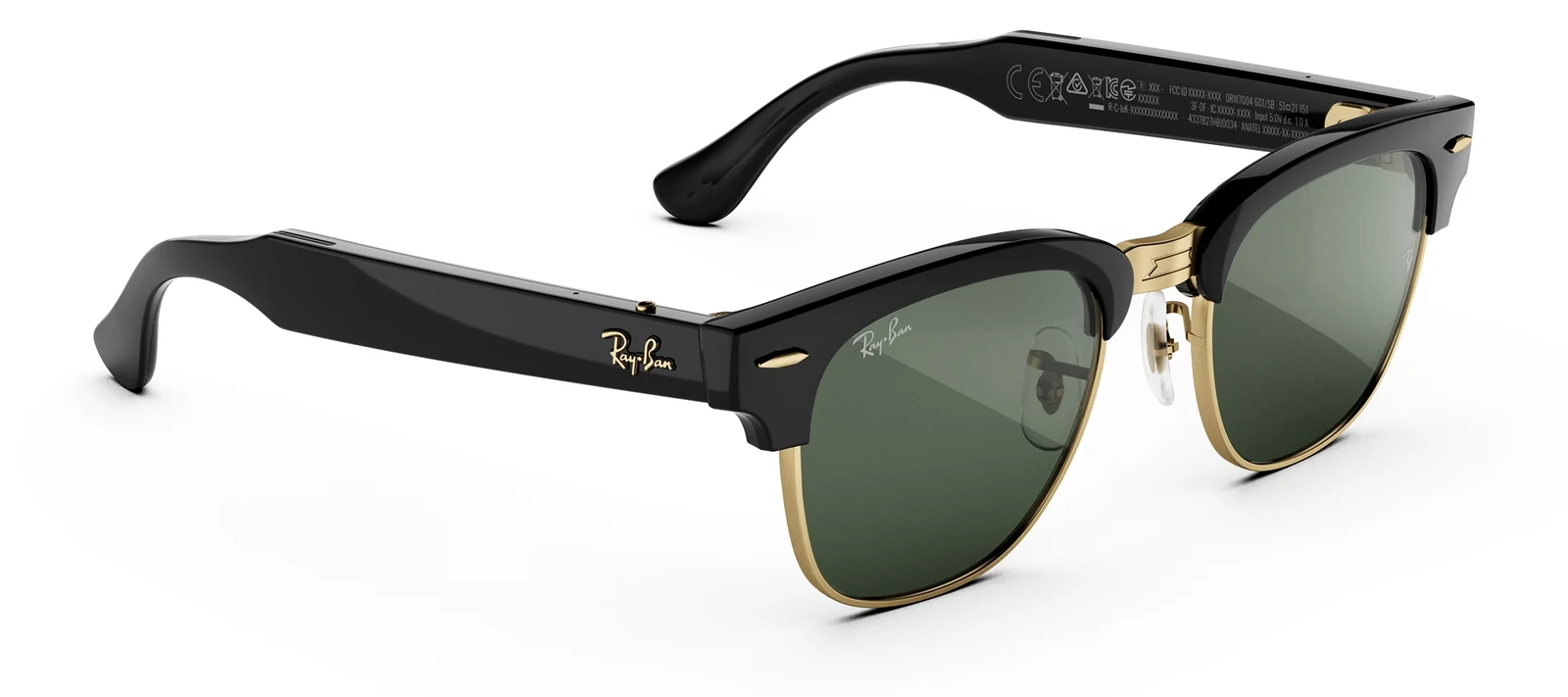 Ray-Ban Meta Audio Clubmaster glasses at three quarters on a white background, a black acetate browline frame with gold trim and green lenses, with no camera lens in either front corner and regulatory markings printed inside the temple arm