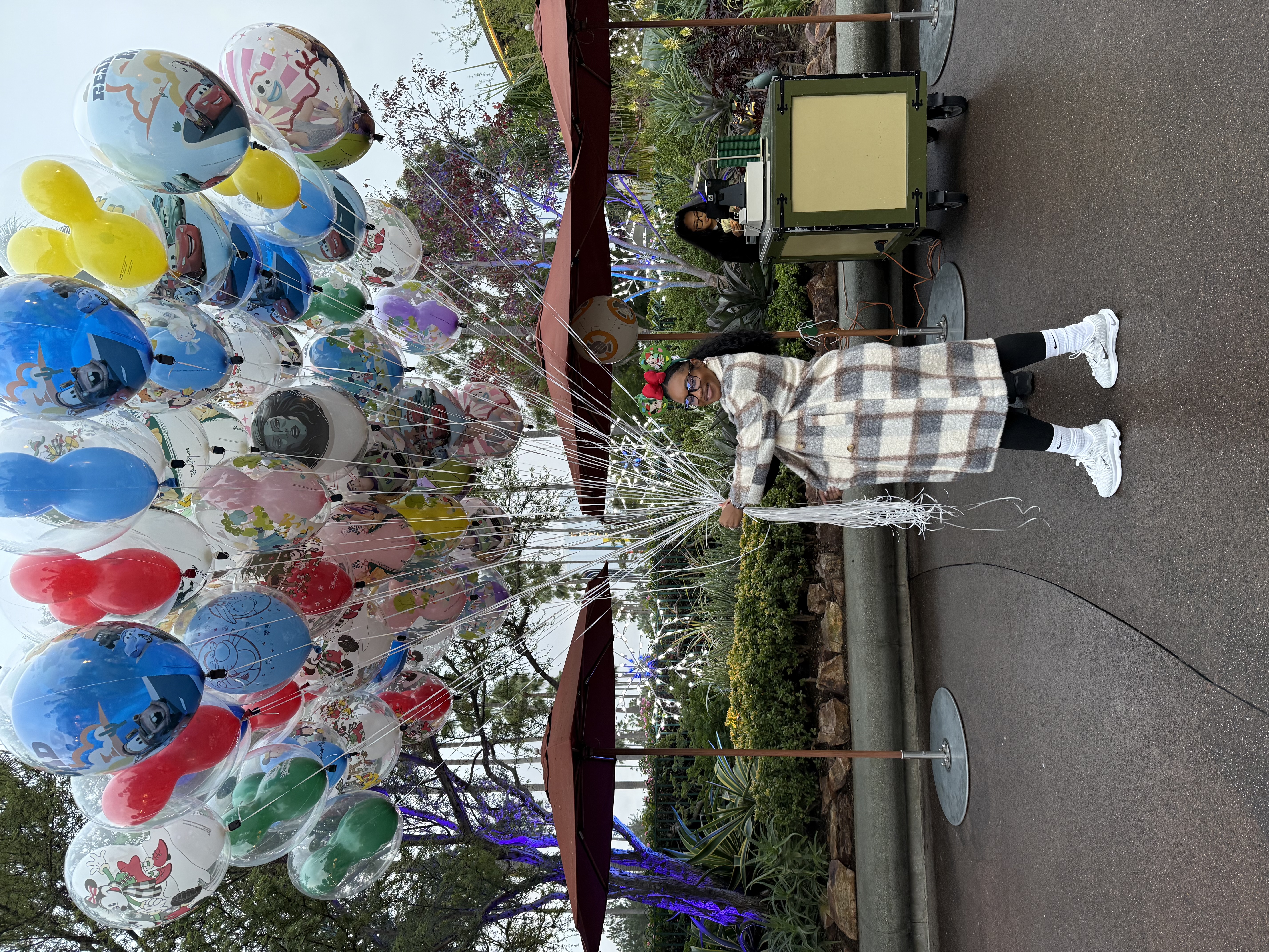 Jachelle Sandoval enjoying a Disney parks experience with character balloons.