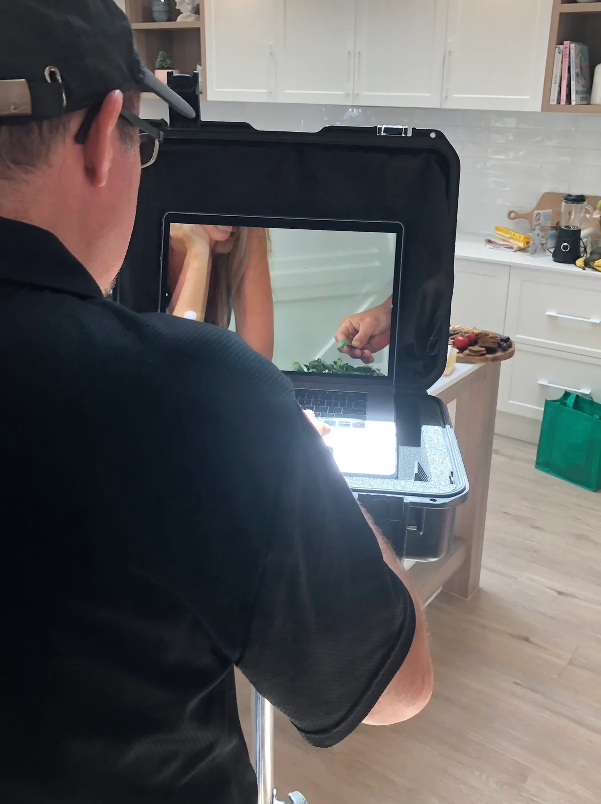Brad Newton behind the camera at our photo shoot, checking the shot on his laptop