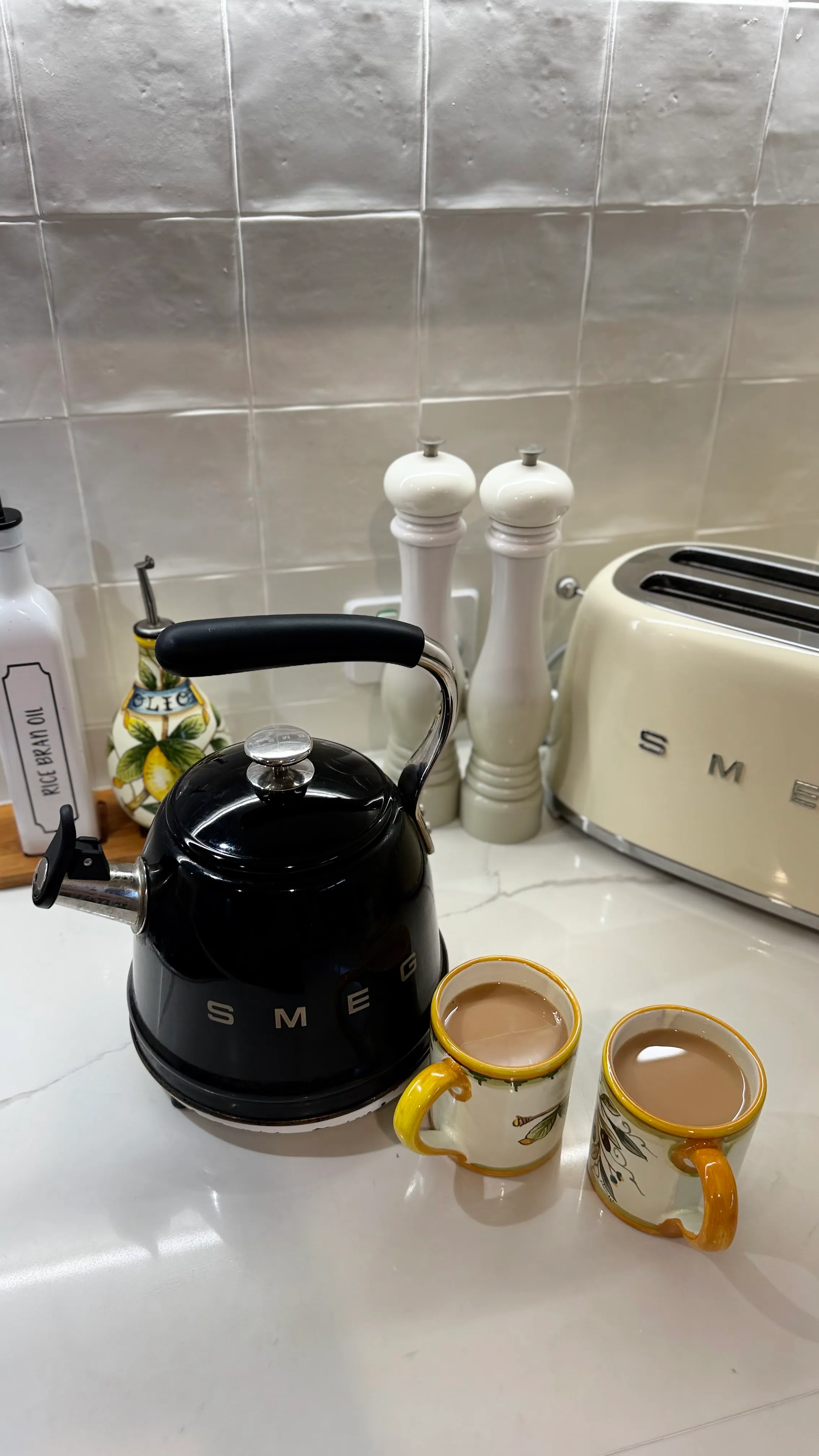 The kettle on and two cups of tea on the bench at our Mooloolaba HQ