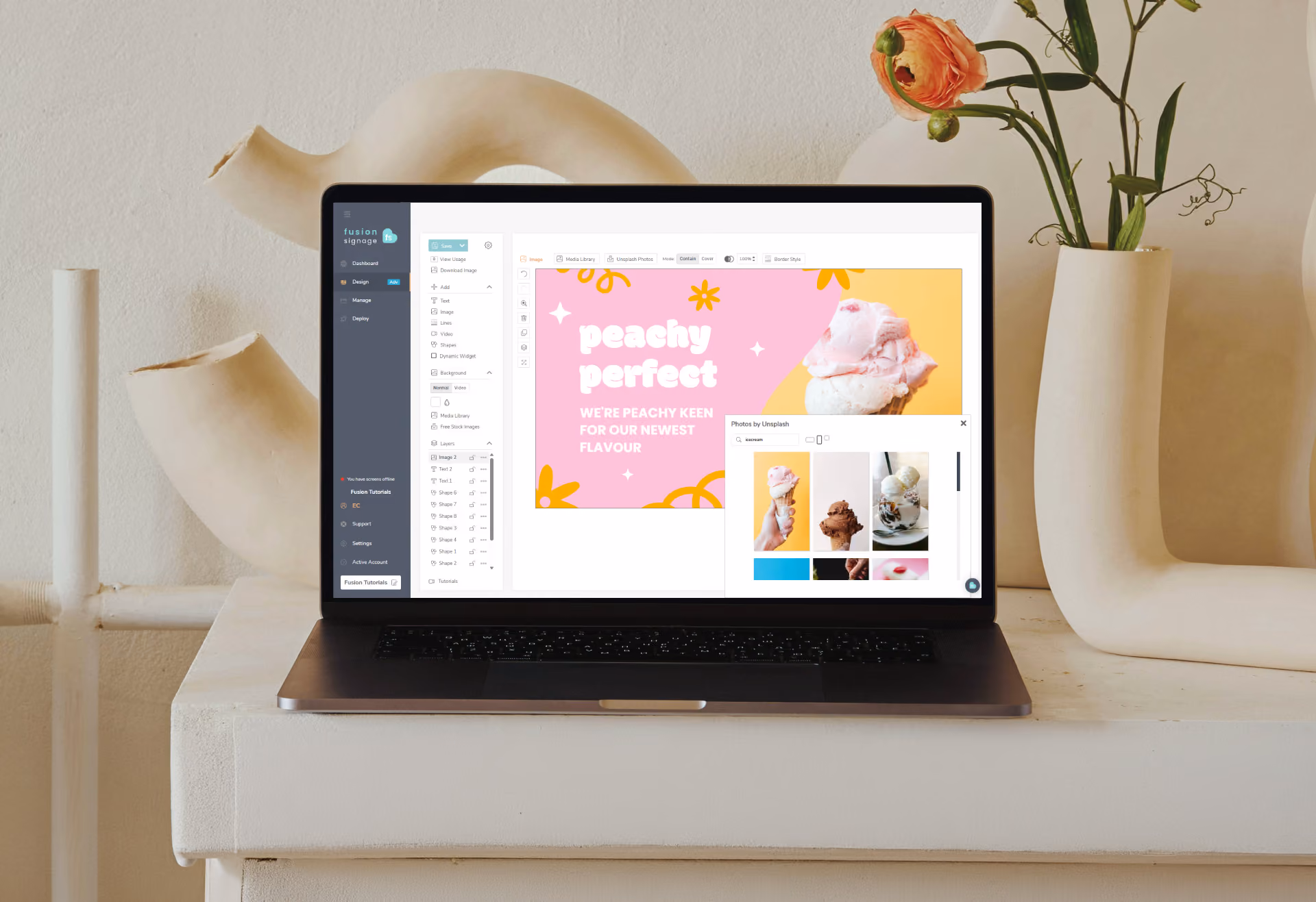 Laptop on white table showing digital signage design for peachy perfect ice cream flavor.