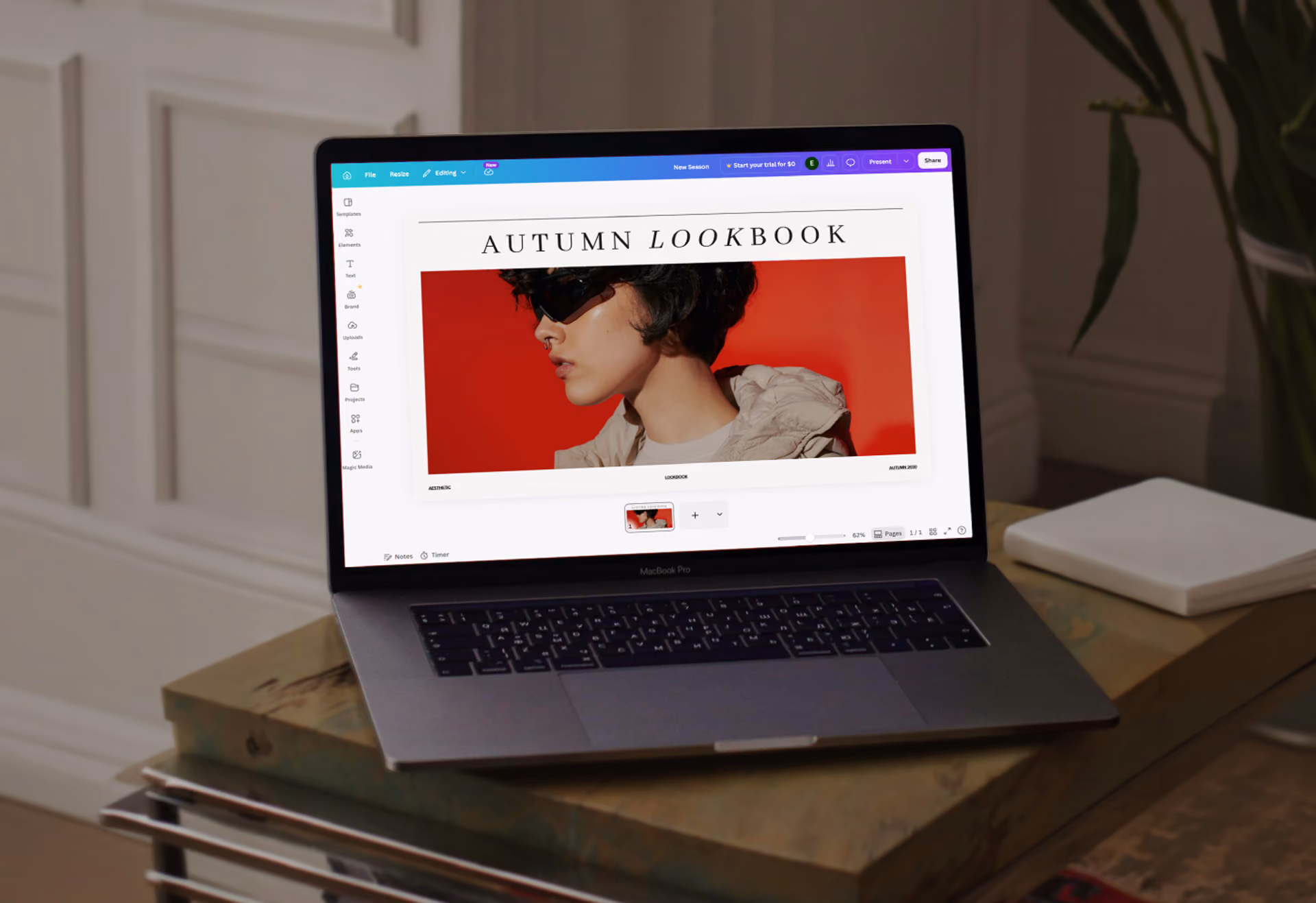 Laptop displaying an autumn lookbook page with a person's side profile against a red background.