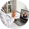 Man in white shirt video chatting on laptop showing a woman on screen indoors.
