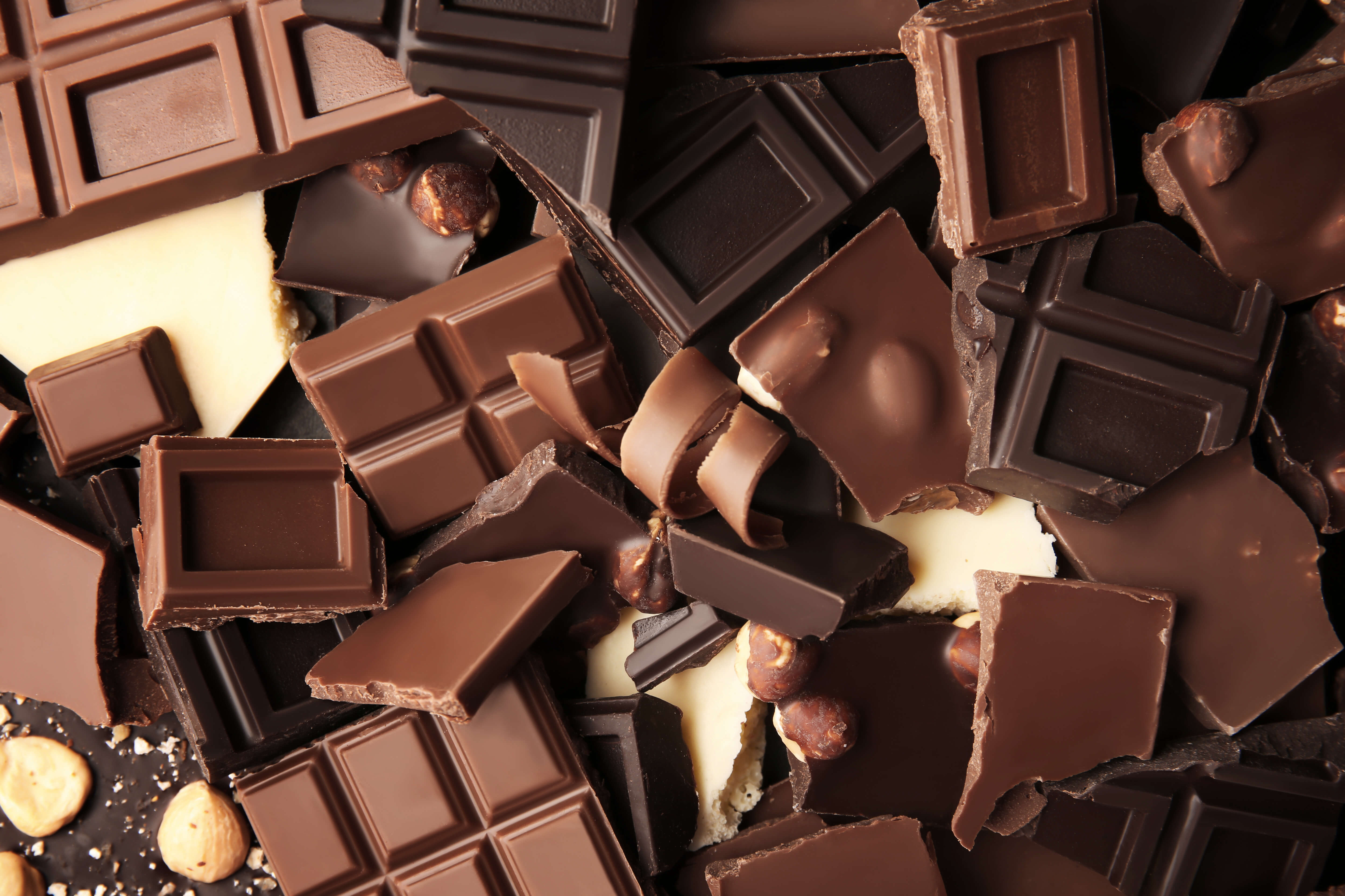 Assorted broken pieces of milk, dark, and white chocolate bars