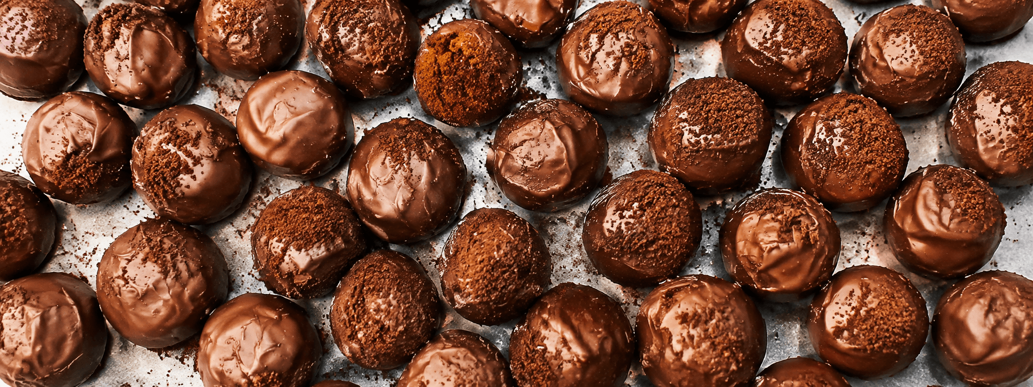 Close-up of rows of chocolate truffles dusted with cocoa powder
