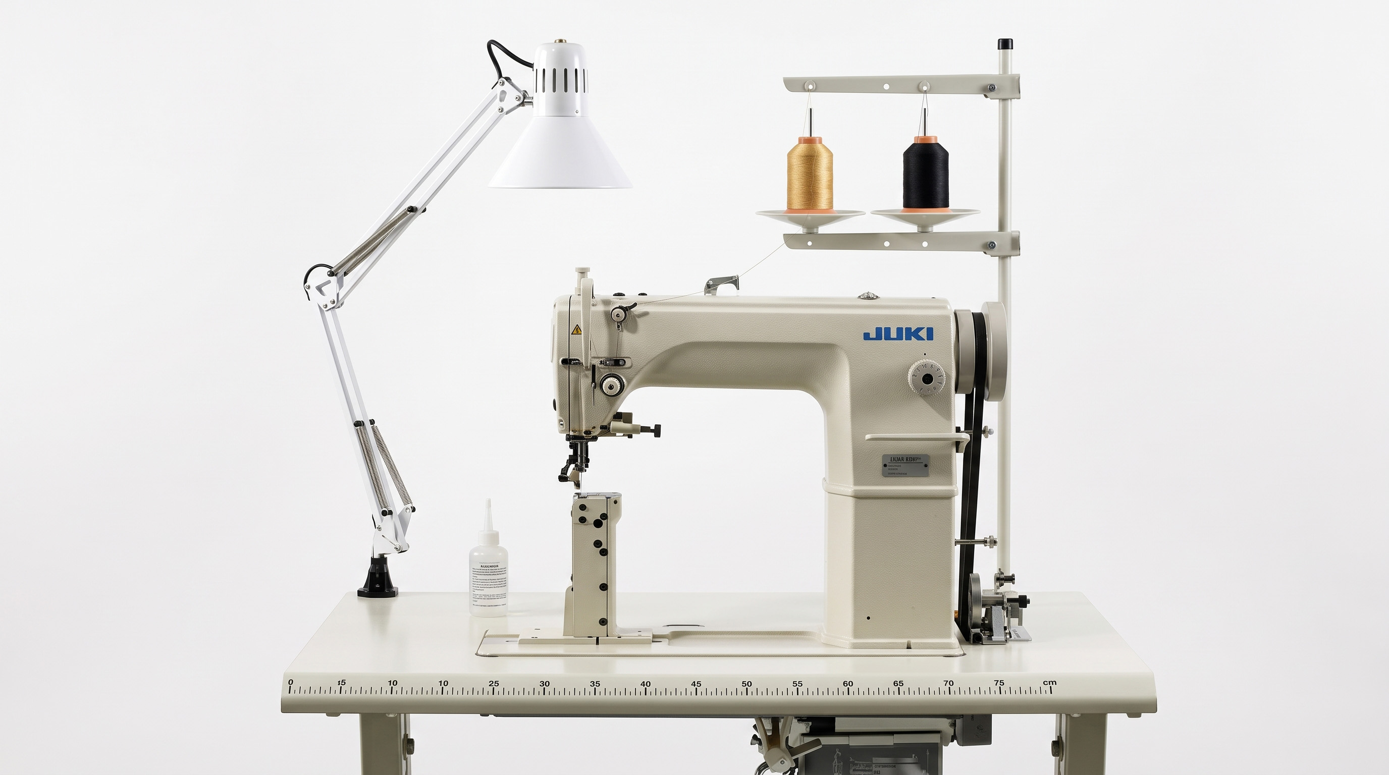 Industrial Juki sewing machine with two thread cones and a task lamp